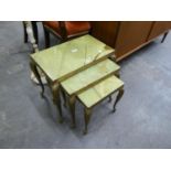 A NEST OF THREE GILT METAL OBLONG COFFEE TABLES, WITH GREEN ONYX TOPS AND A SIMILAR STANDARD LAMP