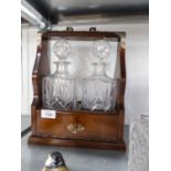 A MODERN MAHOGANY TANTALUS FRAME WITH TWO CUT GLASS SPIRIT DECANTERS, ELECTROPLATE MOUNTS AND HANDLE