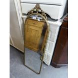 A GILT FRAMED WALL MIRROR WITH ARCHED TOP