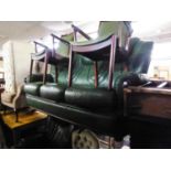 A GREEN LEATHER LOUNGE SUITE OF TWO PIECES, VIZ A THREE SEATER SETTEE AND A LOUNGE CHAIR