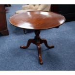 LATE GEORGIAN MAHOGANY REVOLVING TRIPOD OCCASIONAL TABLE, the slightly dished top with birdcage