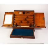 A LATE VICTORIAN OAK SLOPING FRONT PORTABLE DESK, with sunk brass carrying hands, 17 1/4" (44cm)