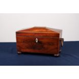 REGENCY ROSEWOOD SARCOPHAGUS SHAPED TEA CADDY with wooden end ring handles, bun feet, the interior