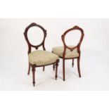 SET OF SIX MID VICTORIAN CARVED WALNUT BALLOON BACK DINING CHAIRS, each with a waisted back with