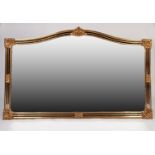 LARGE MODERN GILT FRAMED WALL MIRROR, the arch topped oblong plate housed in a moulded frame with