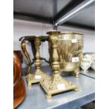 LATE NINETEENTH CENTURY BRASS FOOTMAN WITH PIERCED CIRCULAR TOP AND THREE SCROLL FEET WITH