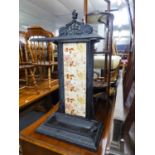 AN EDWARDIAN CAST IRON AND CERAMIC TALL UMBRELLA STAND