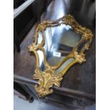 A GILT METAL FRAMED VENETIAN STYLE MIRROR