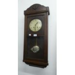 AN OAK CASED WELLINGTON WALL CLOCK