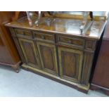 A WALNUTWOOD SIDEBOARD WITH TWO HOLD-OUT LEAVES TO EXTEND THE TOP, THREE FRIEZE DRAWERS OVER THREE