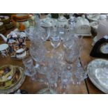 TWO CUT GLASS DECANTERS AND STOPPERS; A SET OF FIVE CUT GLASS SHERRY GLASSES; A SET OF SIX ?