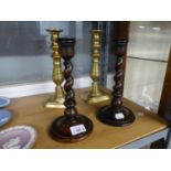 A PAIR OF NINETEENTH CENTURY BRASS CANDLESTICKS, A PAIR OF OAK SPIRAL CANDLESTICKS AND A WROUGHT