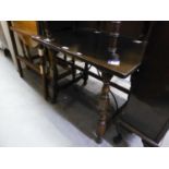 AN OLD OAK OBLONG OCCASIONAL TABLE WITH WROUGHT METAL FANCY STRETCHER