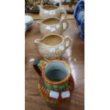 THREE 'MELODY DRIZZLE' PATTERN GREEN, YELLOW AND ORANGE ARTHUR WOOD GRADUATED JUGS (3)