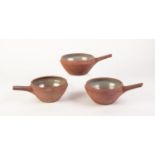 SET OF THREE JOHN LEACH?S MUCHELNEY POTTERY SALT GLAZED DIP BOWLS, with grey glazed interiors,