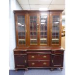 A LARGE MAHOGANY LIBRARY BOOKCASE, WITH FOUR LEADED AND GLAZED DOORS, ON AN EARLIER MAHOGANY DRESSER