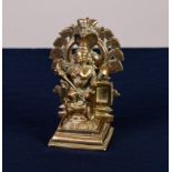 19th CENTURY HINDU CAST BRASS SMALL PORTABLE FIGURE OF A FEMALE DEITY WITH FOUR ARMS one foot raised