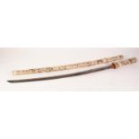 A JAPANESE MEIJI PERIOD KATANA in probably marine ivory hilt and scabbard shallowy carved autour and