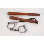 HARDWOOD TRUNCHEON, 14? (35.6cm) long, ANOTHER, SMALLER, and a PAIR OF VINTAGE IRON HANDCUFFS, (3)
