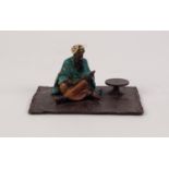 ?BERGM? COLD PAINTED BRONZE FIGURE OF A MIDDLE EASTERN MAN SAT CROSS LEGGED ON A CARPET, reading