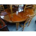 EDWARDIAN MAHOGANY CIRCULAR DINING TABLE EXTENDING WITH A WINDING ACTION, ON FOUR INLAID MAHOGANY