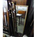 FIVE WALKING STICKS AND A GENTLEMAN?S UMBRELLA AND A ROBING MIRROR, IN GILT FRAME