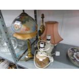A SATIN BRASS TABLE LAMP ON TRIFORM BASE AND THE DECORATED GLASS BONNET SHAPED SHADE; A BRASS URN