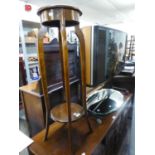 AN OAK CIRCULAR TWO TIER TORCHERE, WITH FOUR TALL CABRIOLE LEGS AND AN OVAL FRAMELESS WALL MIRROR