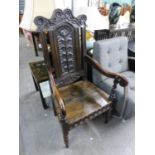 A LATE VICTORIAN CARVED OAK 'WAINSCOT' STYLE OPEN ARMCHAIR