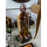 AN OXYDISED METAL 'KNIGHT' PATTERN FIRESIDE COMPANION STAND