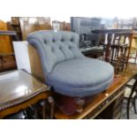 AN ANTIQUE NURSING CHAIR, WITH LARGE CIRCULAR SEAT AND LOW BUTTON BACK RAISED ON TURNED FRONT