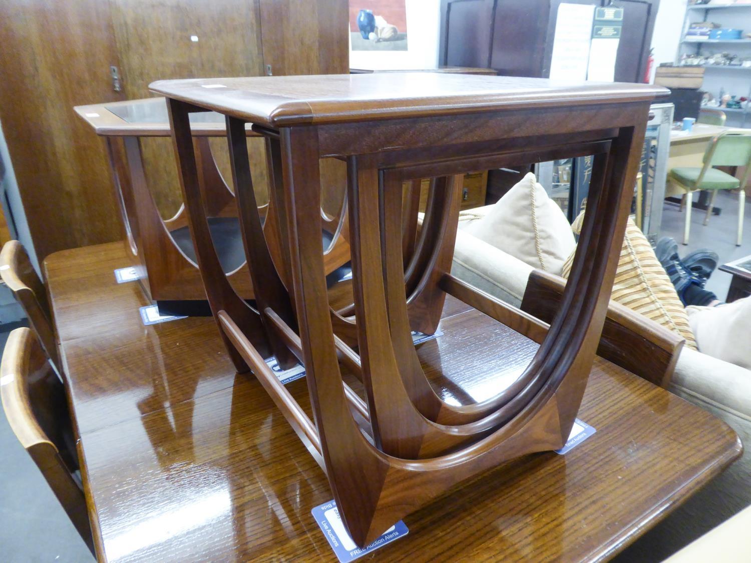 1960?S G-PLAN TEAK NEST OF THREE OBLONG COFFEE TABLES, ON CONTINUOUS SUPPORTS