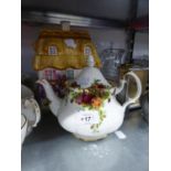 A POTTERY COTTAGE PATTERN LARGE BISCUIT BARREL AND A ROYAL ALBERT 'OLD COUNTRY ROSES' TEAPOT (2)