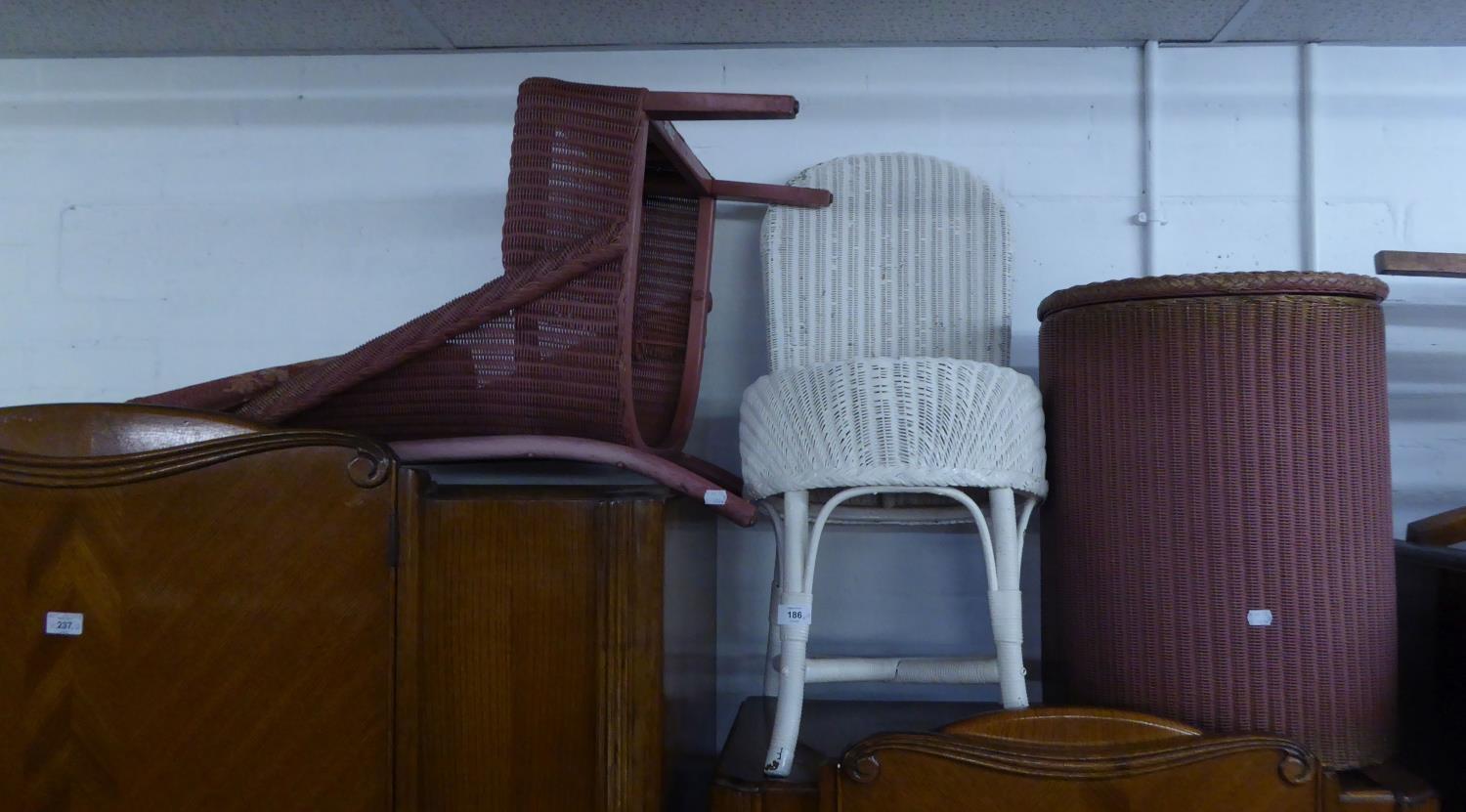 A LLOYD LOOM LOW CHAIR WITH STUFFED SEAT, A 'D' SHAPED LOOM LINEN RECEIVER AND ANOTHER WICKER