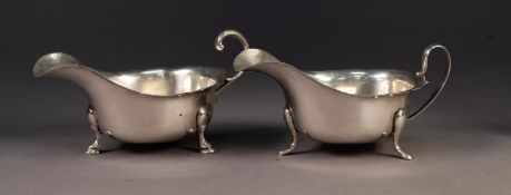 TWO GEORGIAN STYLE SILVER SAUCE BOATS with cyma borders, one with flying scroll handle ad stepped