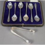GEORGE V CASED SET OF SIX SILVER COFFEE SPOONS, initialled, and the MATCHING PAIR OF SUGAR TONGS,