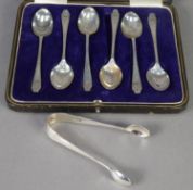 GEORGE V CASED SET OF SIX SILVER COFFEE SPOONS, initialled, and the MATCHING PAIR OF SUGAR TONGS,