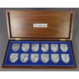 THE DANBURY MINT SET OF TWELVER SILVER SHIELD SHAPED INGOTS depicting 'The Royal Arms' as borne by