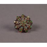 WHORL PATTERN BROOCH set with 25 emeralds, comprising a centre daisy cluster of 7 emeralds and