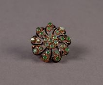 WHORL PATTERN BROOCH set with 25 emeralds, comprising a centre daisy cluster of 7 emeralds and