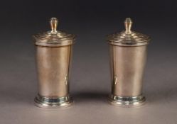 PAIR OF ART DECO STERLING SILVER PEPPERETTES, each of tapering form with stepped cover and base, 2.