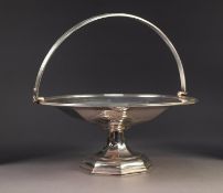 GEORGE V SILVER SWING HANDLED PEDESTAL CAKE BASKET BY WALKER & HALL, of circular form with reeded