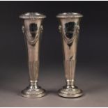 PAIR OF VICTORIAN EMBOSSED WEIGHTED SILVER POSY VASES IN THE ADAMS STYLE, each of tapering form with