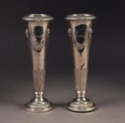 PAIR OF VICTORIAN EMBOSSED WEIGHTED SILVER POSY VASES IN THE ADAMS STYLE, each of tapering form with