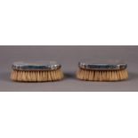 EDWARD VIII PAIR OF ENGINE TURNED SILVER BACKED MILITARY HAIRBRUSHES, of shaped oblong form,