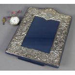 MODERN SCROLL EMBOSSED, SILVER FRONTED PHOTOGRAPH FRAME, with arch top and blue plush easel support,