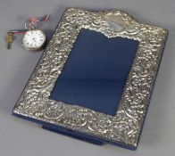 MODERN SCROLL EMBOSSED, SILVER FRONTED PHOTOGRAPH FRAME, with arch top and blue plush easel support,