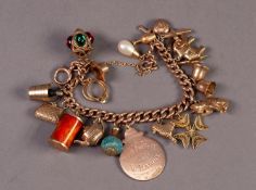 9ct GOLD CURB PATTERN CHARM BRACELET, with ring clasp and 18, mainly 9ct gold charms, including a