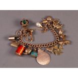 9ct GOLD CURB PATTERN CHARM BRACELET, with ring clasp and 18, mainly 9ct gold charms, including a