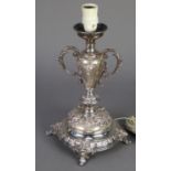 CONTINENTAL SILVER COLOURED METAL ORNATE TABLE LAMP, the whole repousse with floral festoons,